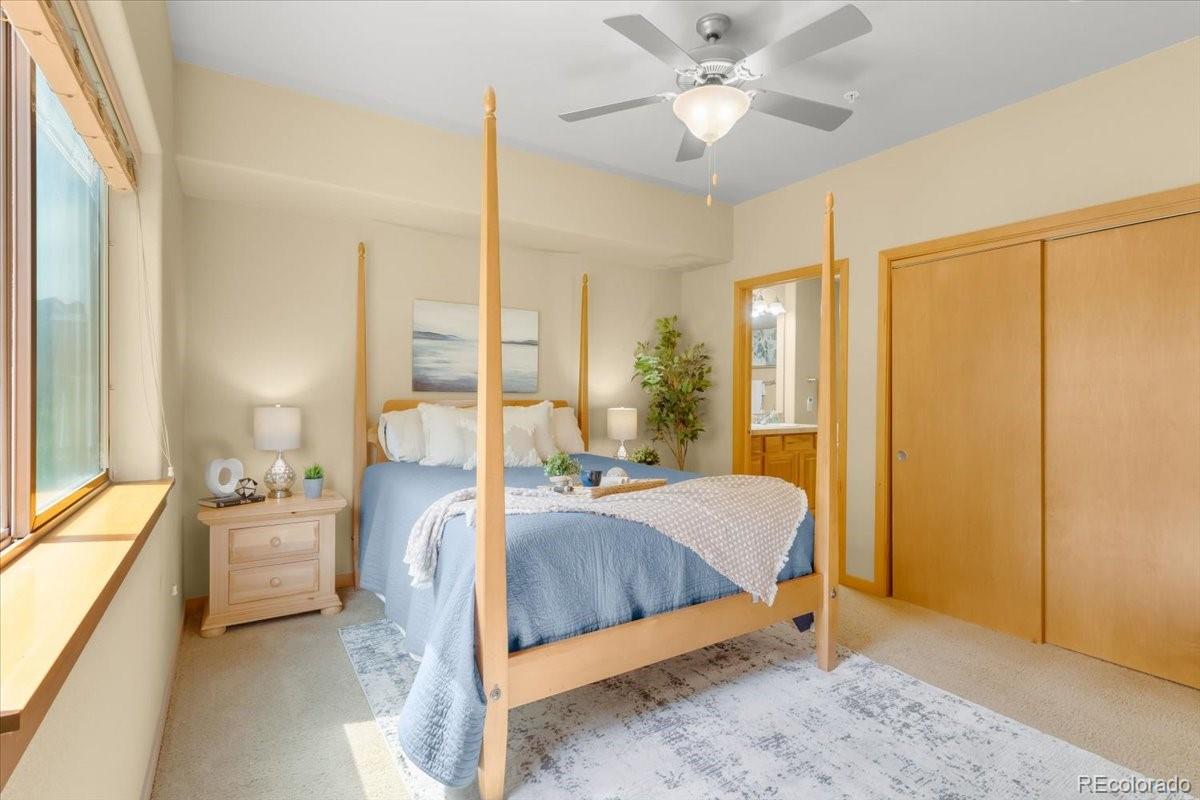 140 Sterling Loop, Unit 202 Fraser, CO 80442 - Photo 16 of 24 a bedroom with a bed and large windows