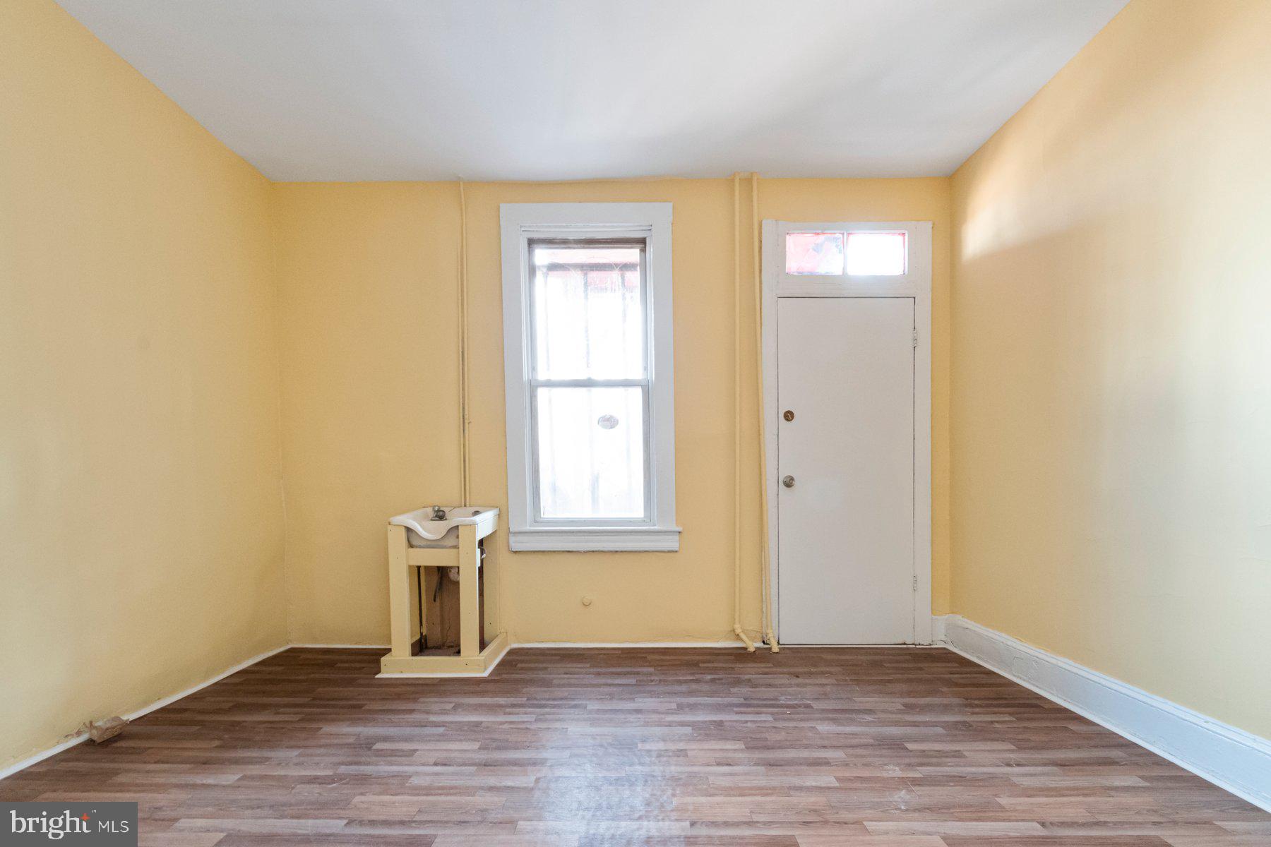 2273 Reisterstown Road Baltimore, MD 21217 - Photo 11 of 27 an empty room with wooden floor and windows