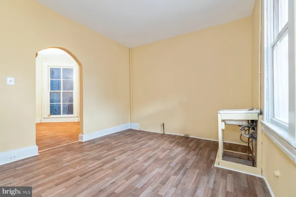 a view of a room with wooden floor and window