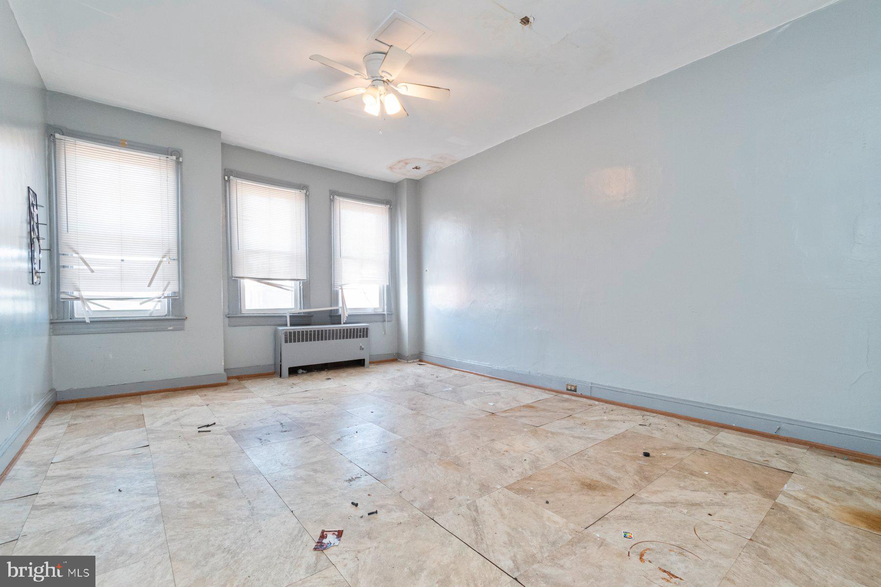 2273 Reisterstown Road Baltimore, MD 21217 - Photo 25 of 27 an empty room with chandelier fan and windows