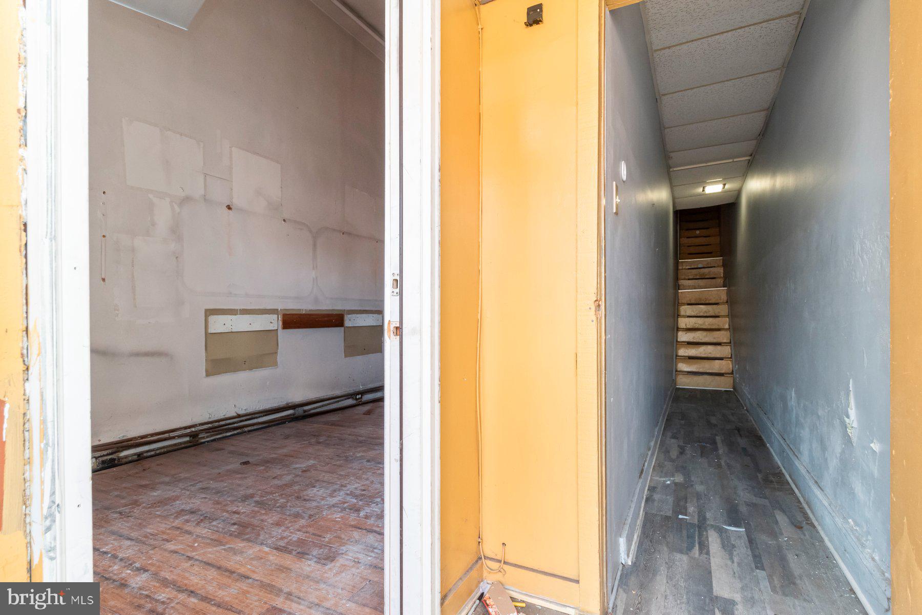 2273 Reisterstown Road Baltimore, MD 21217 - Photo 4 of 27 a view of a hallway with wooden floor and a bathroom