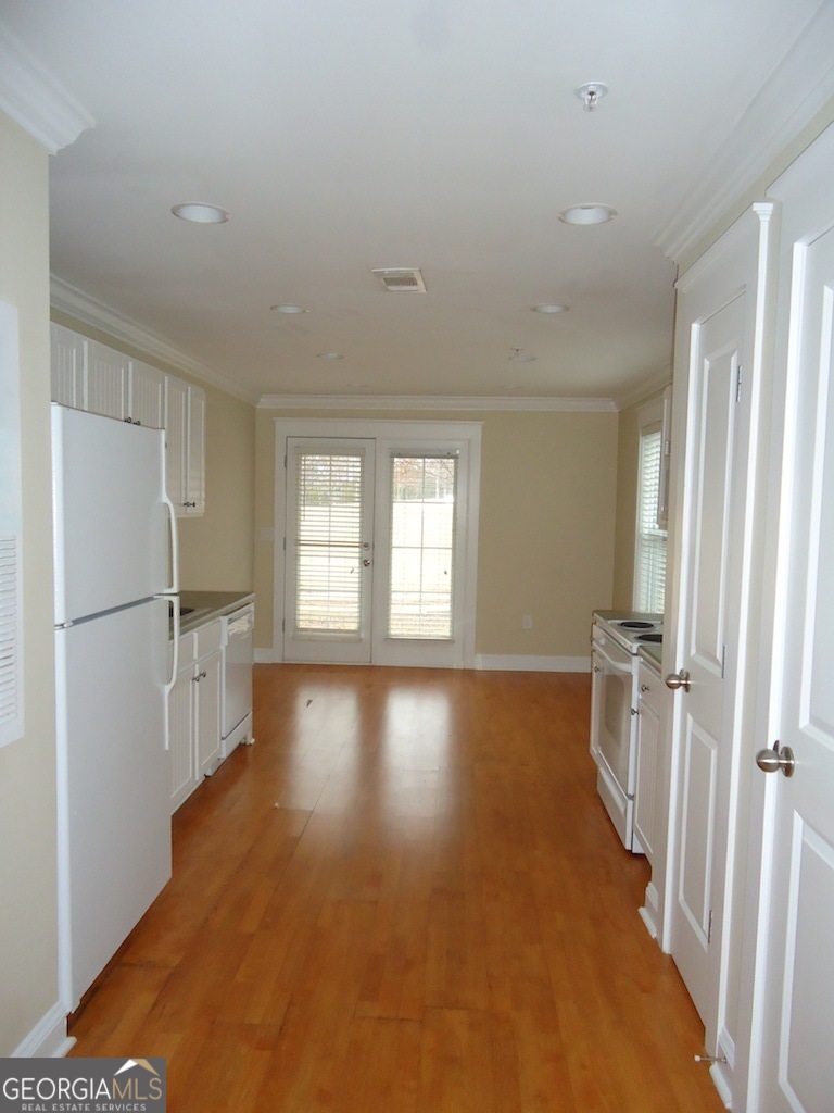 1035 South Barnett Shoals Road, Unit 1012 Athens, GA 30605 - Photo 11 of 27 a view of a kitchen with a sink refrigerator and wooden floor