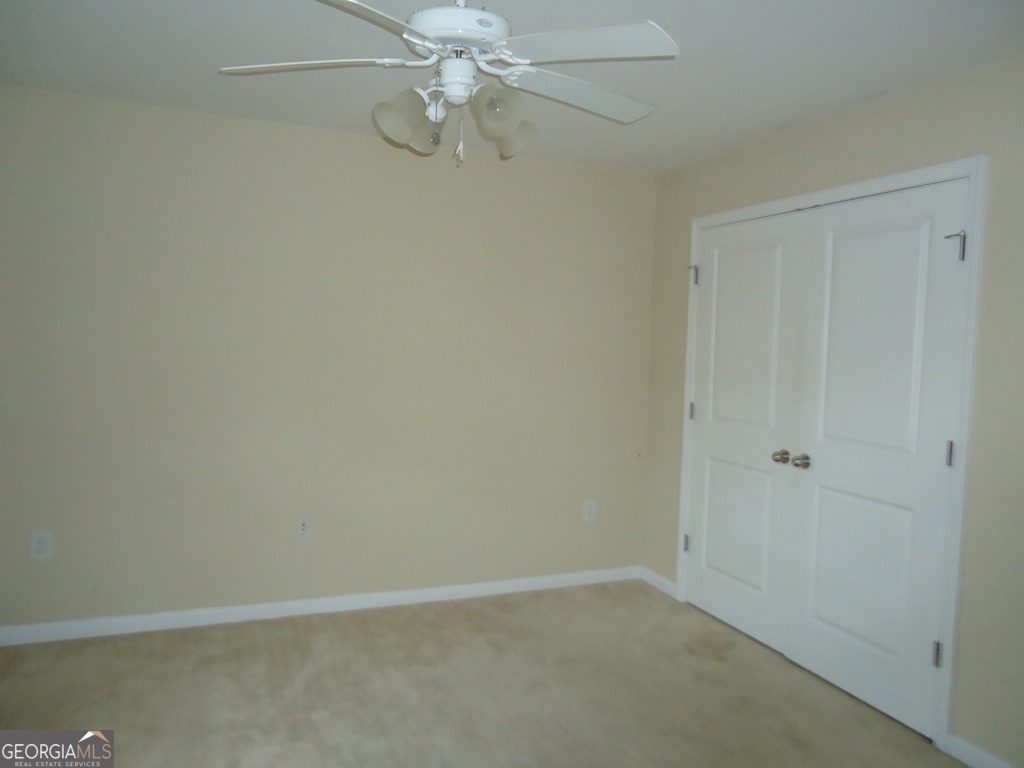 1035 South Barnett Shoals Road, Unit 1012 Athens, GA 30605 - Photo 14 of 27 an empty room with a window and a fan