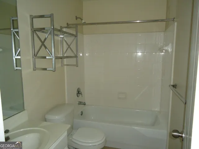 a bathroom with a shower and a toilet