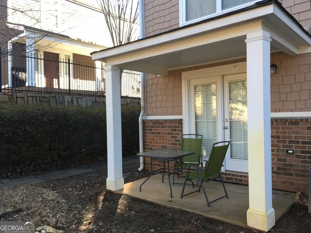 a view of a house with backyard and sitting area