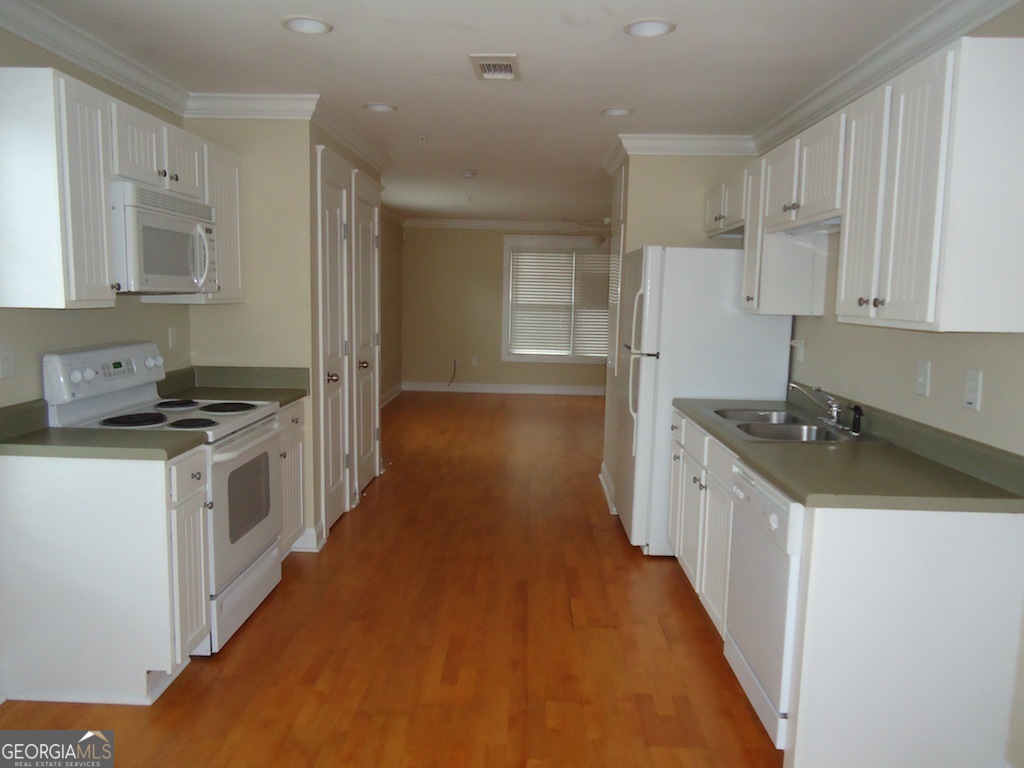 1035 South Barnett Shoals Road, Unit 1012 Athens, GA 30605 - Photo 9 of 27 a kitchen with a sink a stove and refrigerator