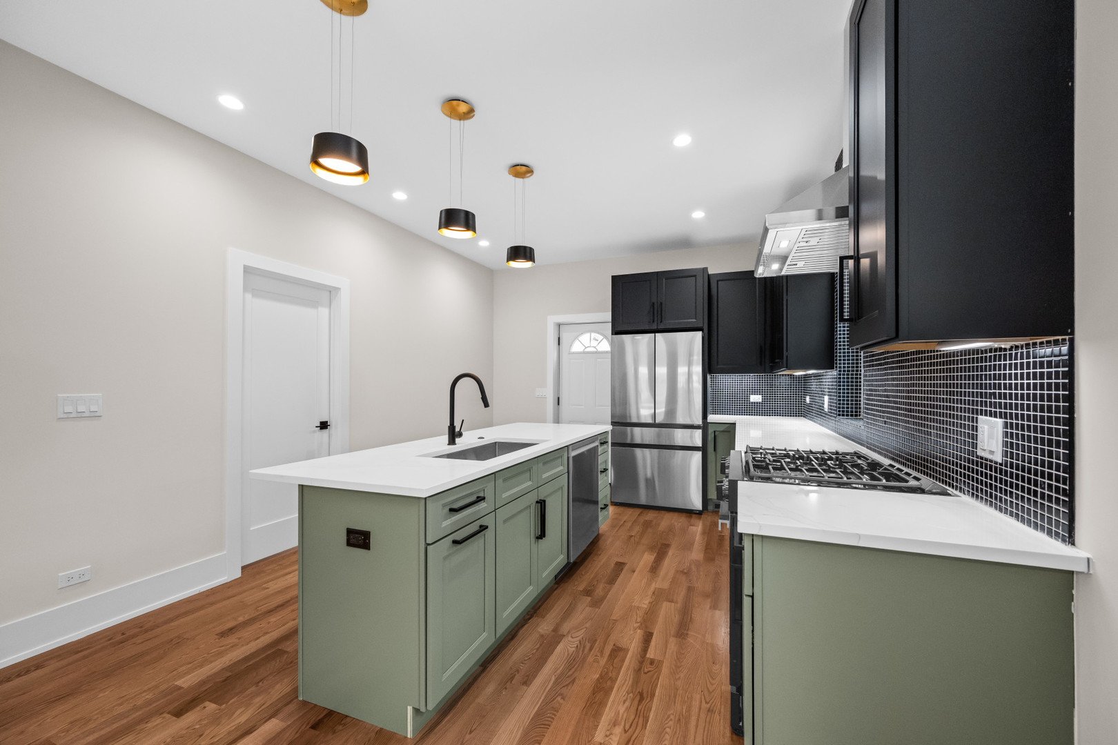 7827 South Merrill Avenue Chicago, IL 60649 - Photo 12 of 42 a kitchen with stainless steel appliances granite countertop a sink a stove and a refrigerator