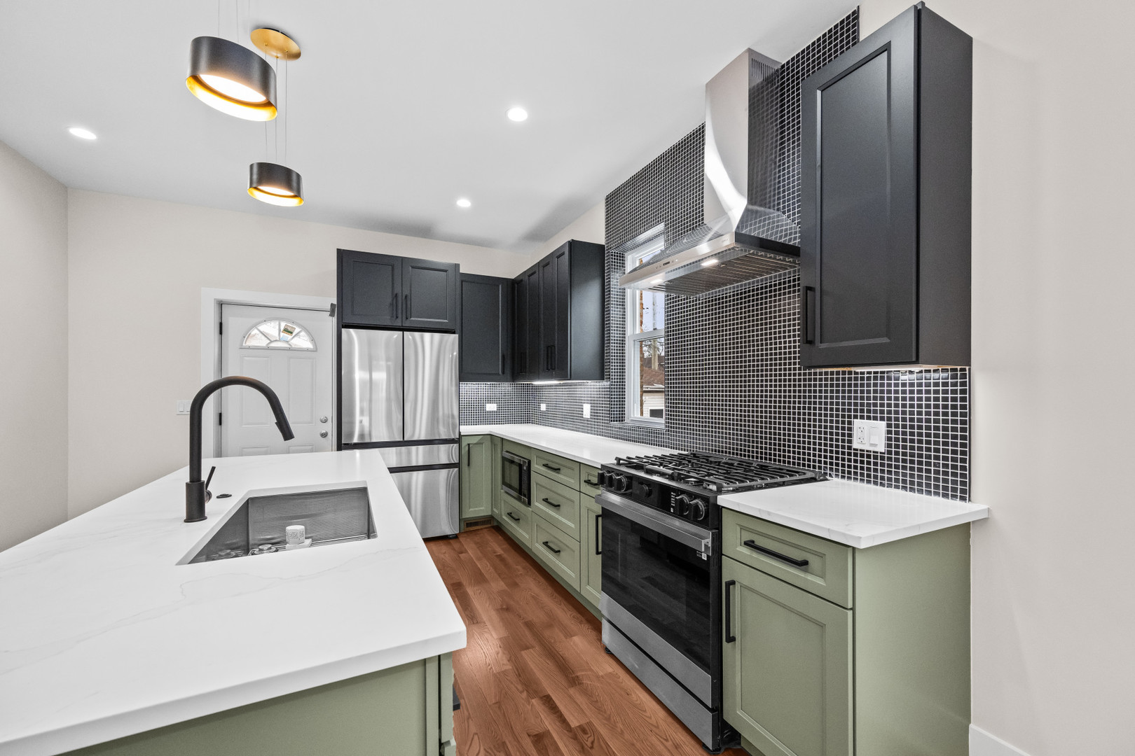 7827 South Merrill Avenue Chicago, IL 60649 - Photo 13 of 42 a kitchen with stainless steel appliances granite countertop a stove a sink and a microwave