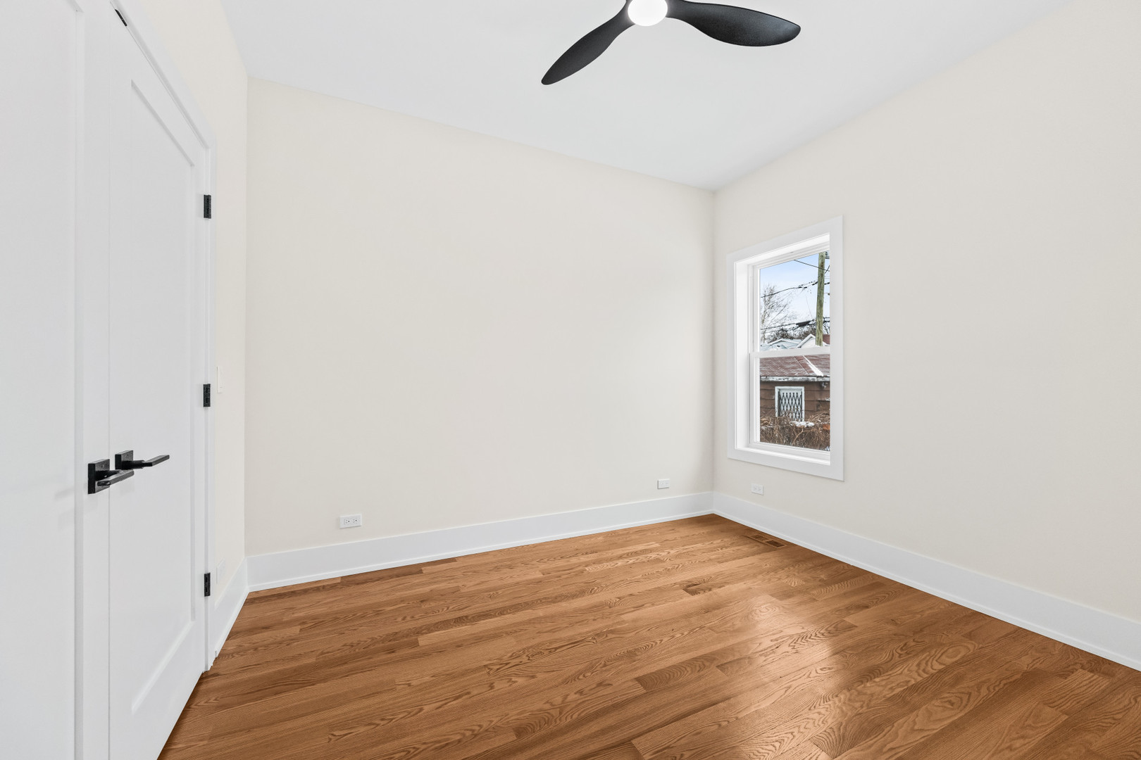 7827 South Merrill Avenue Chicago, IL 60649 - Photo 16 of 42 a view of an empty room with wooden floor