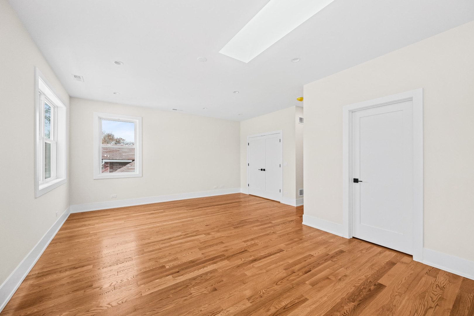 7827 South Merrill Avenue Chicago, IL 60649 - Photo 22 of 42 a view of an empty room with wooden floor and a window