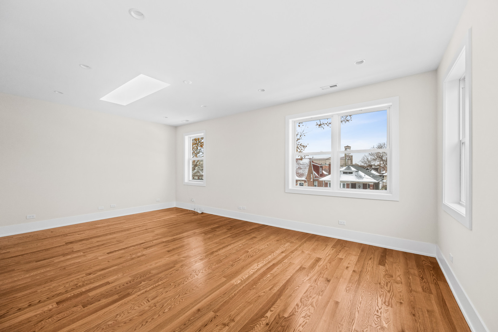 7827 South Merrill Avenue Chicago, IL 60649 - Photo 23 of 42 a view of an empty room with wooden floor and a window