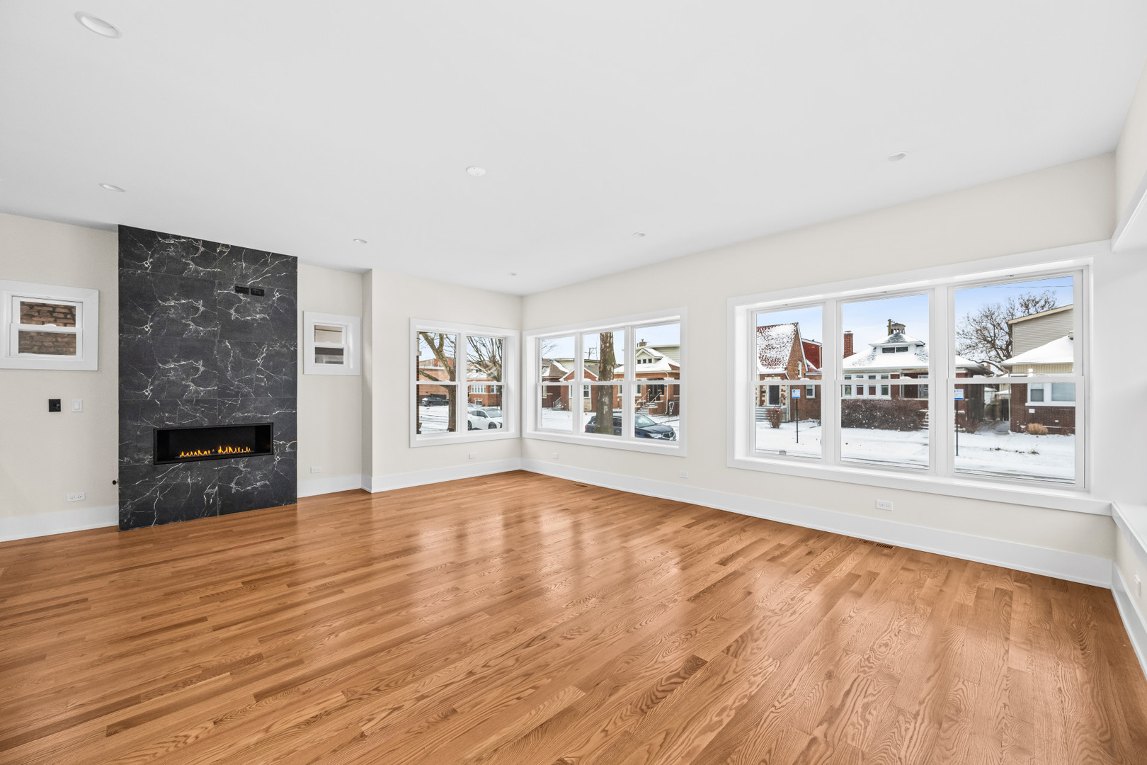 7827 South Merrill Avenue Chicago, IL 60649 - Photo 4 of 42 a view of an empty room with wooden floor and a window