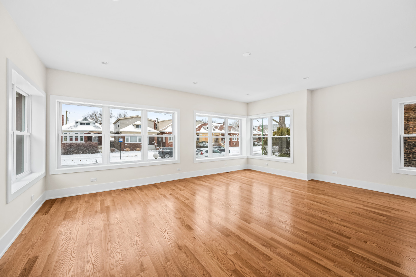 7827 South Merrill Avenue Chicago, IL 60649 - Photo 8 of 42 a view of an empty room with wooden floor and a window