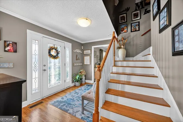 a view of an entryway with wooden floor and windows