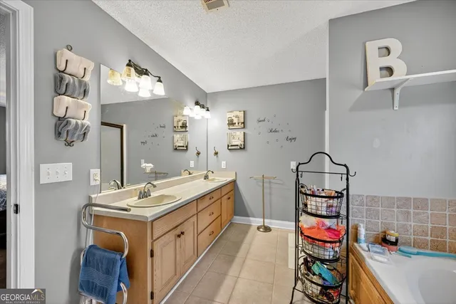 a bathroom with a tub sink and mirror