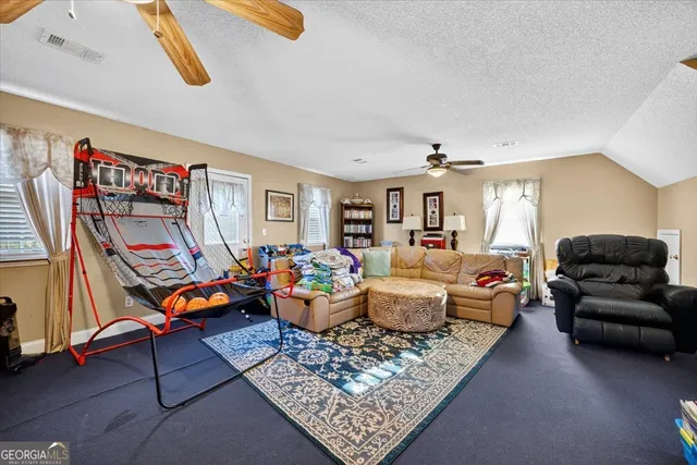 a living room with furniture a rug and a window