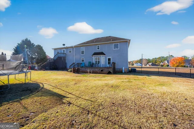 a swimming pool with outdoor seating and yard