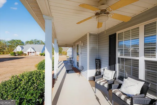 a balcony with furniture and a potted plant