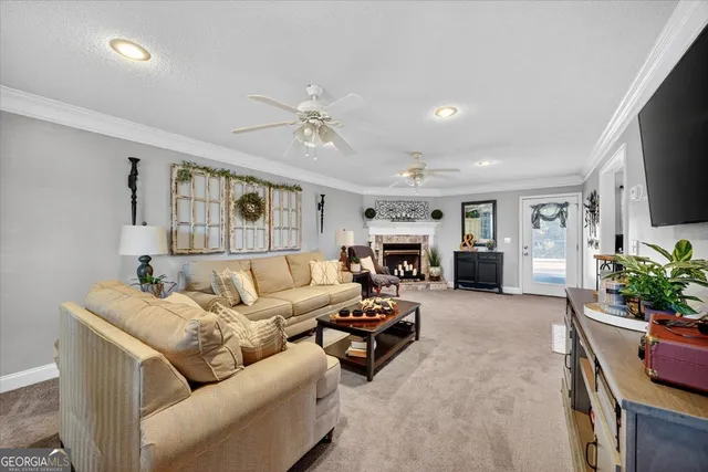 a living room with furniture flat screen tv and a fireplace