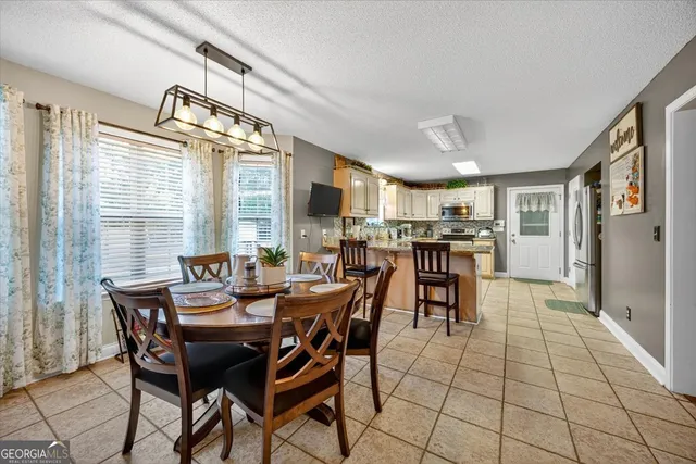 a dining room with furniture and window