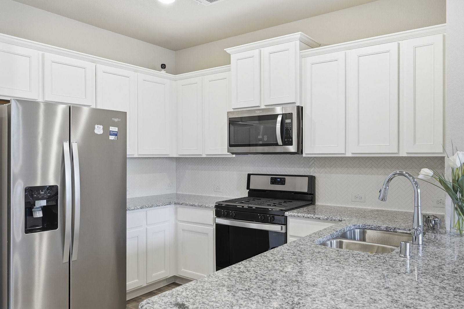 8038 Scanlan Trace Missouri City, TX 77459 - Photo 12 of 25 a kitchen with stainless steel appliances granite countertop a refrigerator stove a sink and microwave