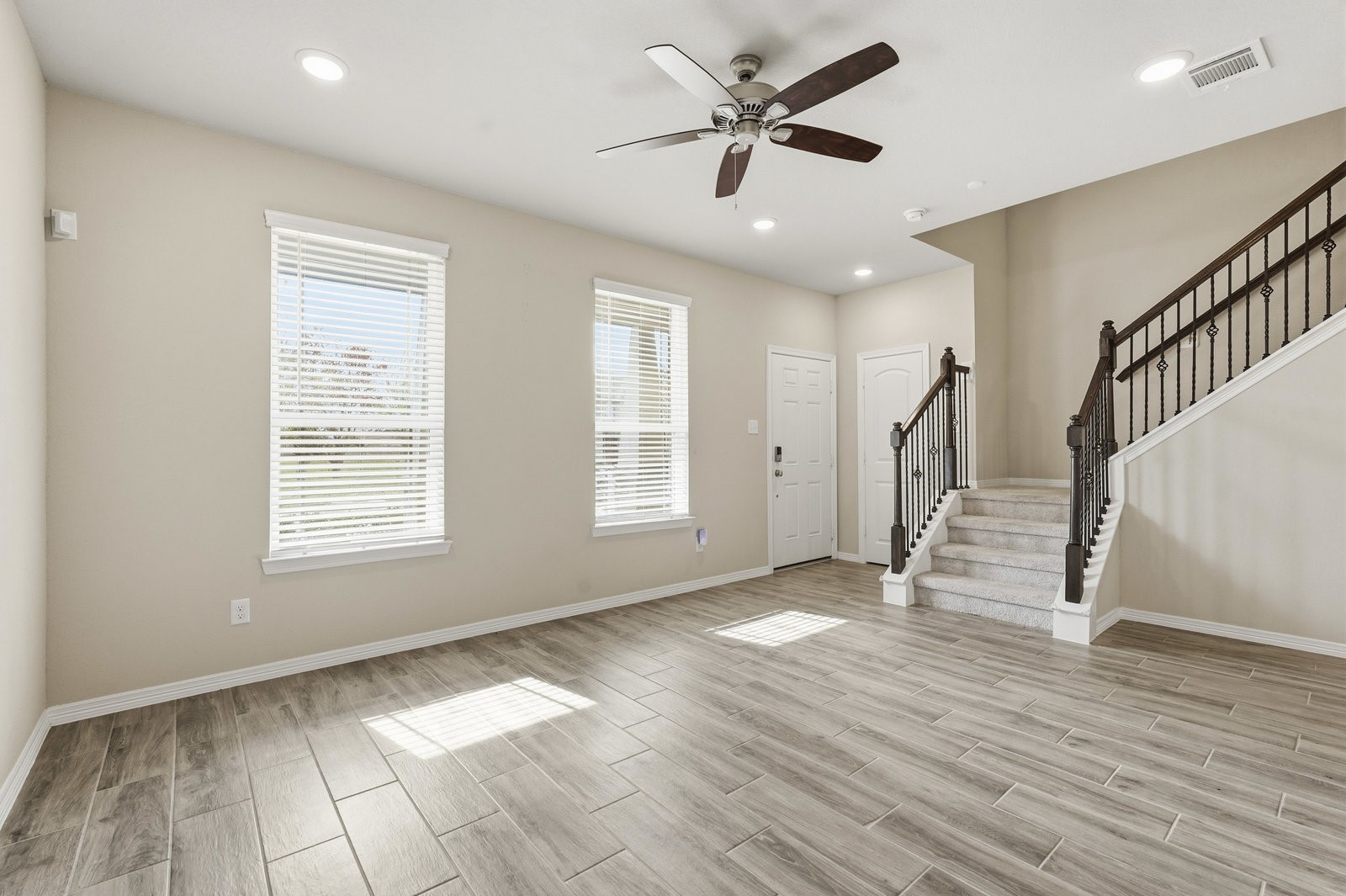 8038 Scanlan Trace Missouri City, TX 77459 - Photo 6 of 25 a view of an empty room with wooden floor and a window