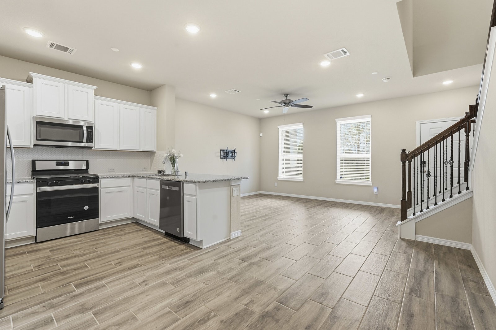 8038 Scanlan Trace Missouri City, TX 77459 - Photo 9 of 25 a kitchen with stainless steel appliances granite countertop a stove a sink and a refrigerator