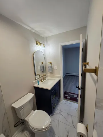 a white toilet sitting next to a bathroom sink