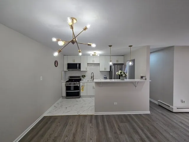 a view of a kitchen with microwave and cabinets
