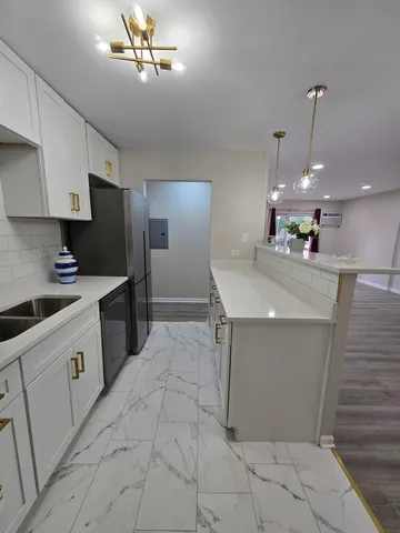 a kitchen with a sink and refrigerator