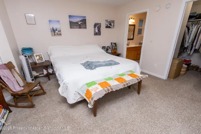 a bedroom with a bed and a chair