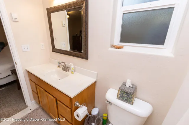a view of a room with wooden floor and furniture
