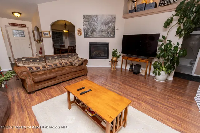 a living room with furniture flat screen tv and a fireplace