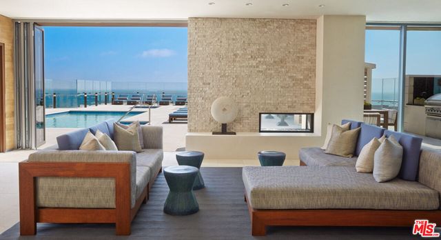 a living room with furniture and a floor to ceiling window