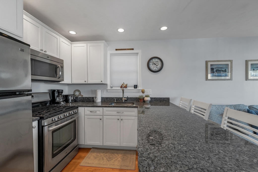 144 Lake Street, Unit 11 Laconia, NH 03246 - Photo 12 of 38 a kitchen with a sink cabinets and stainless steel appliances