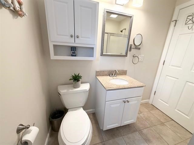 144 Lake Street, Unit 11 Laconia, NH 03246 - Photo 18 of 38 a bathroom with a sink a toilet and mirror