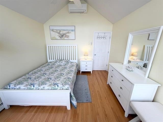 144 Lake Street, Unit 11 Laconia, NH 03246 - Photo 26 of 38 a large bedroom with a bed and wooden floor