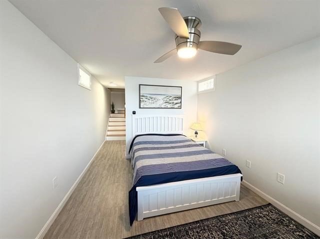144 Lake Street, Unit 11 Laconia, NH 03246 - Photo 28 of 38 a bedroom with a bed and a chandelier