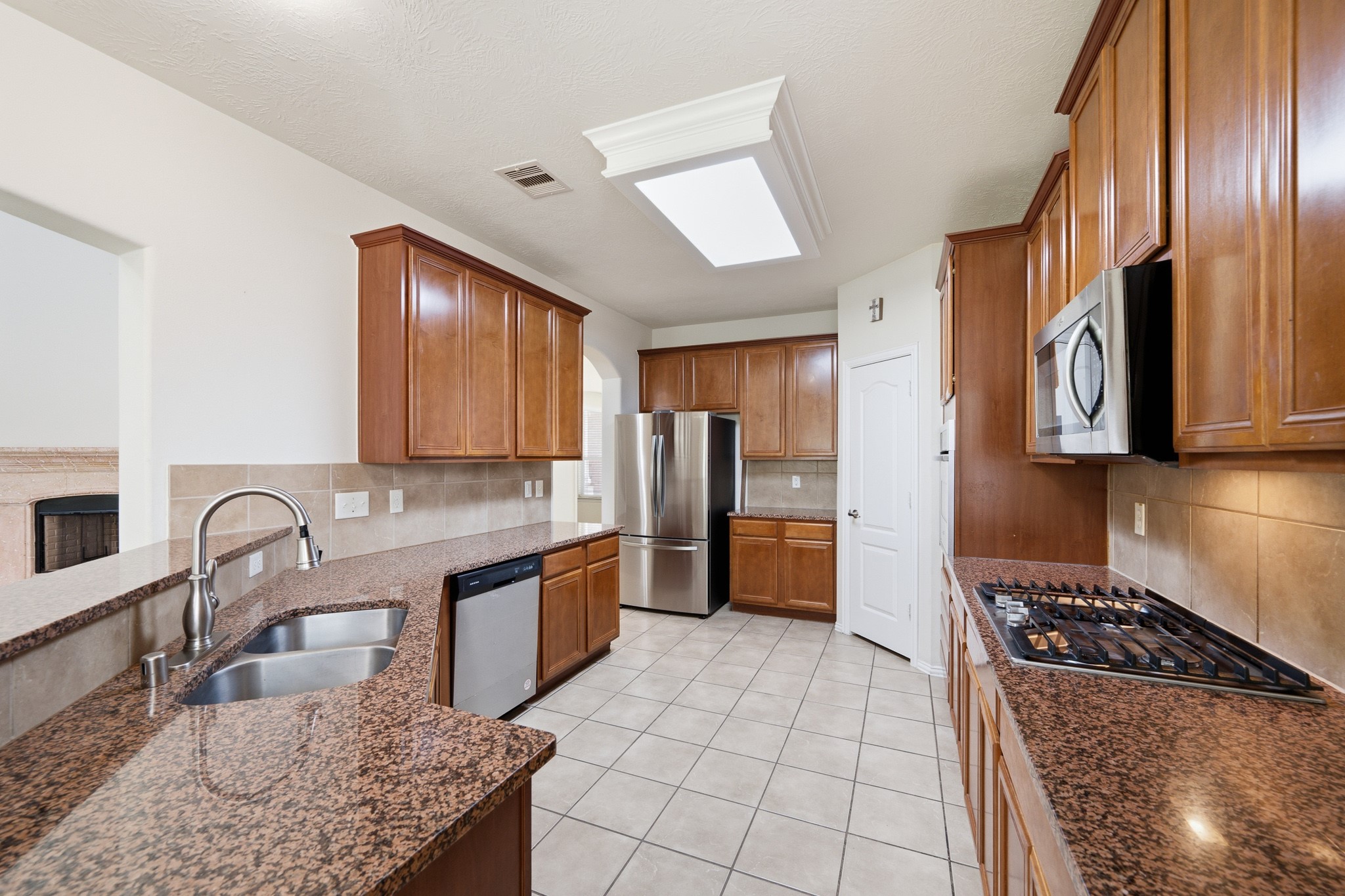 2117 Rushing Spring Drive Pearland, TX 77584 - Photo 15 of 42 Experience culinary delight in this spacious kitchen, featuring elegant granite countertops, modern stainless steel appliances, and ample cabinetry for all your storage needs.