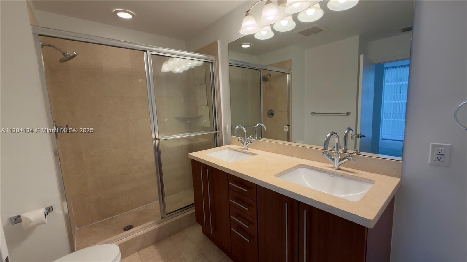 1111 Southwest 1st Avenue, Unit 2516N Miami, FL 33130 - Photo 21 of 31 a bathroom with a sink mirror and a shower