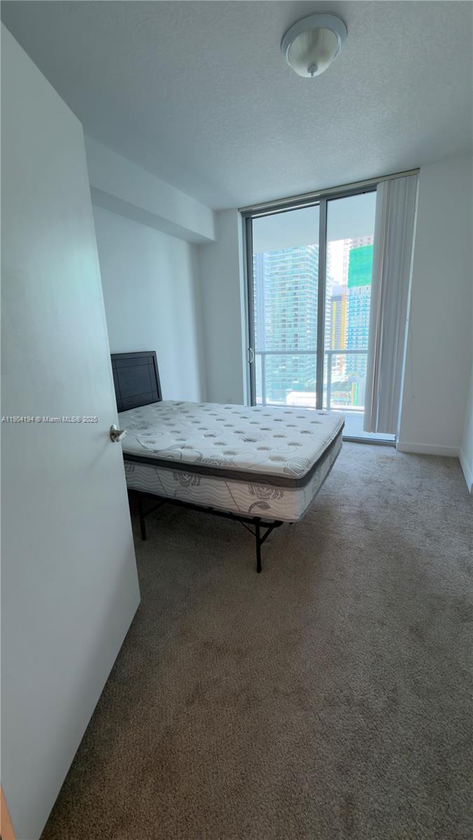 1111 Southwest 1st Avenue, Unit 2516N Miami, FL 33130 - Photo 27 of 31 a room with a bed table and window