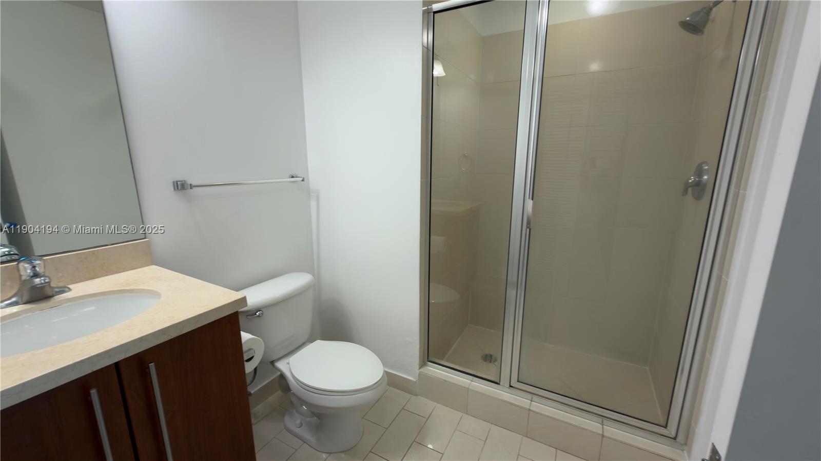 1111 Southwest 1st Avenue, Unit 2516N Miami, FL 33130 - Photo 30 of 31 a bathroom with a sink a toilet a mirror and shower