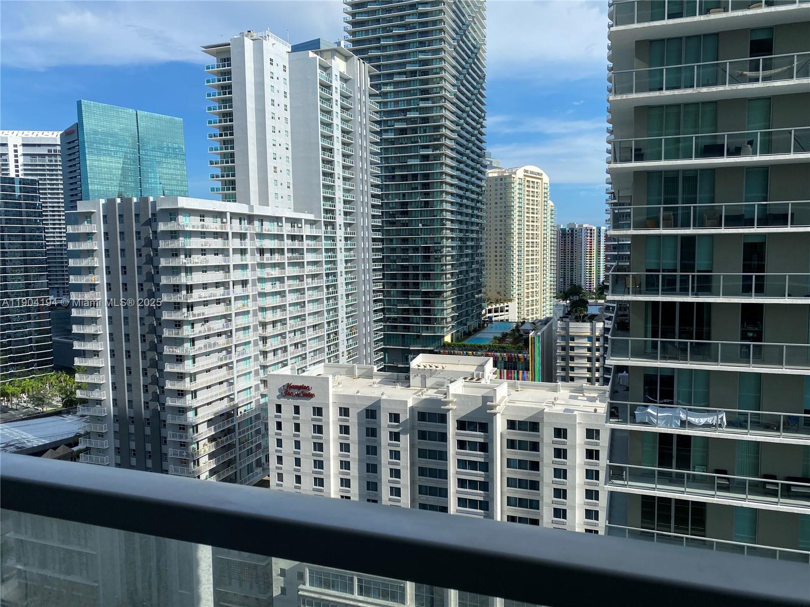 1111 Southwest 1st Avenue, Unit 2516N Miami, FL 33130 - Photo 3 of 31 a view of a balcony with a couple of cars parked in front of a building