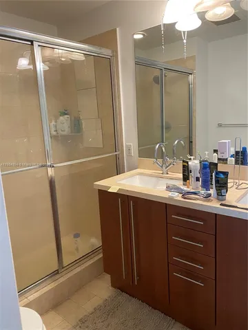 a bathroom with a tub sink and mirror