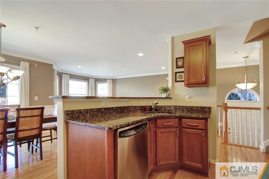 21 Raritan Reach Road, Unit 11 South Amboy, NJ 08879 - Photo 11 of 28 a kitchen with stainless steel appliances granite countertop a stove and a sink