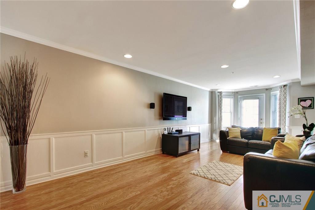21 Raritan Reach Road, Unit 11 South Amboy, NJ 08879 - Photo 15 of 28 a living room with furniture a flat screen tv and a refrigerator