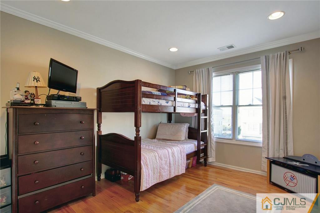 21 Raritan Reach Road, Unit 11 South Amboy, NJ 08879 - Photo 23 of 28 a bedroom with a bed and a flat screen tv