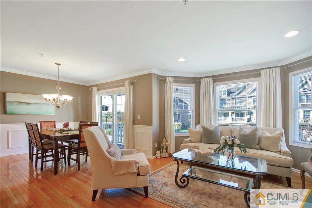 21 Raritan Reach Road, Unit 11 South Amboy, NJ 08879 - Photo 4 of 28 a living room with furniture a table and large windows