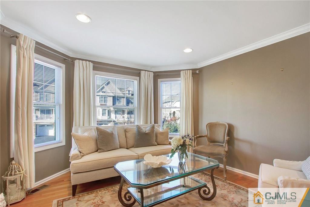21 Raritan Reach Road, Unit 11 South Amboy, NJ 08879 - Photo 5 of 28 a living room with furniture a table and a large window