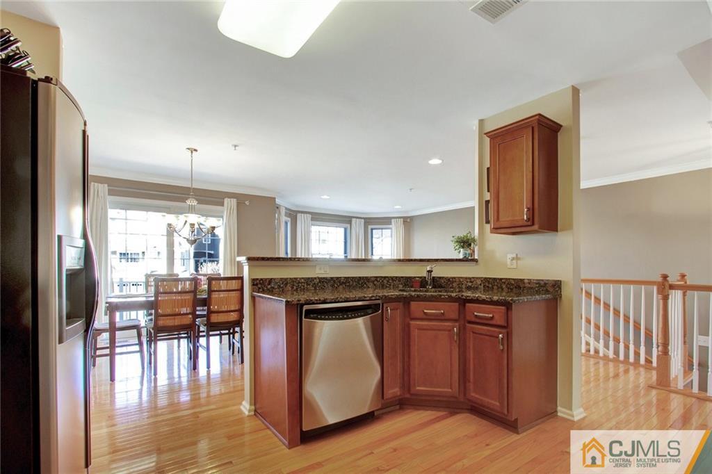 21 Raritan Reach Road, Unit 11 South Amboy, NJ 08879 - Photo 9 of 28 a kitchen with stainless steel appliances granite countertop a stove and a wooden cabinets